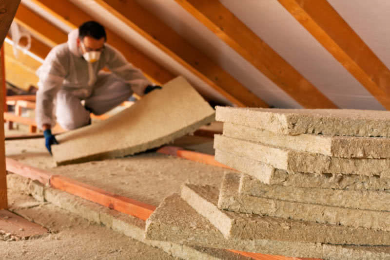 man installing insulation